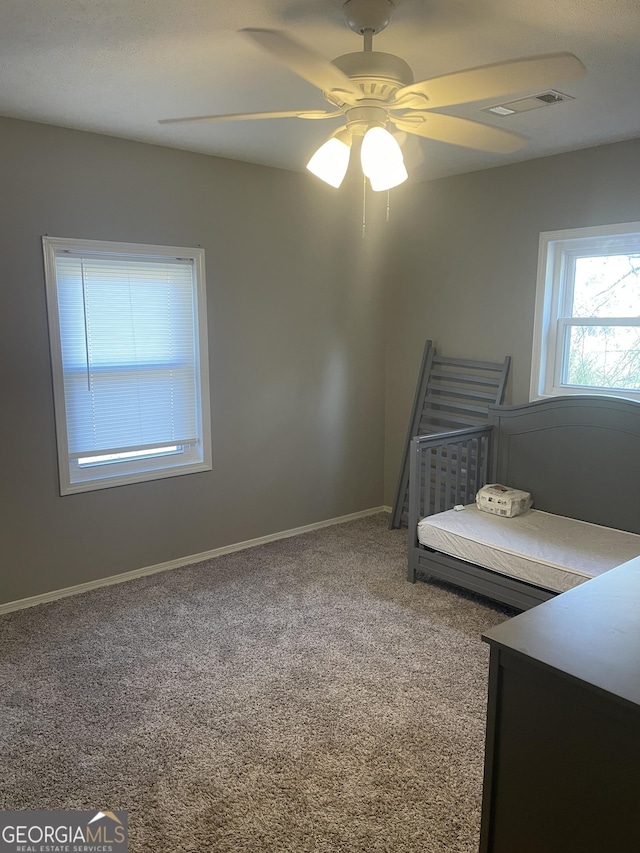 unfurnished bedroom featuring ceiling fan and carpet floors