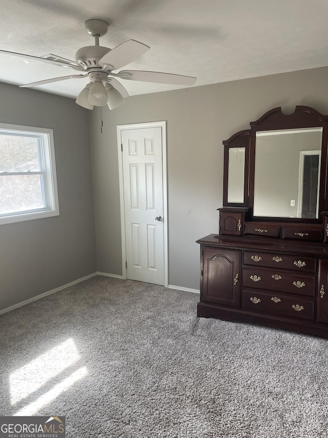 unfurnished bedroom with light colored carpet and ceiling fan