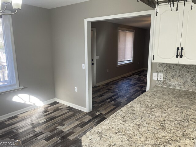 unfurnished dining area featuring dark hardwood / wood-style flooring