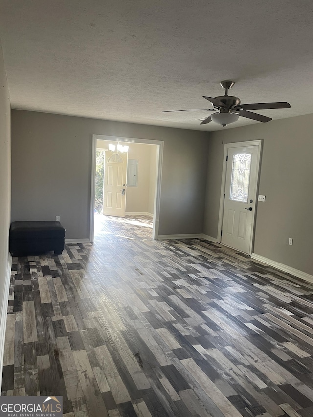 entryway featuring ceiling fan, dark hardwood / wood-style flooring, and a textured ceiling