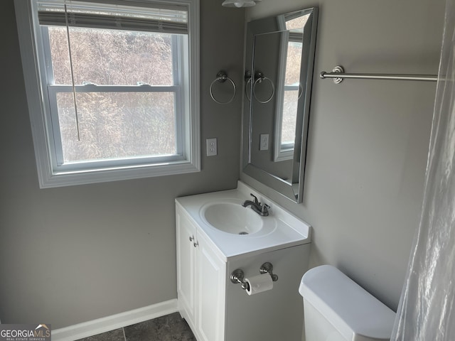 bathroom featuring vanity and toilet