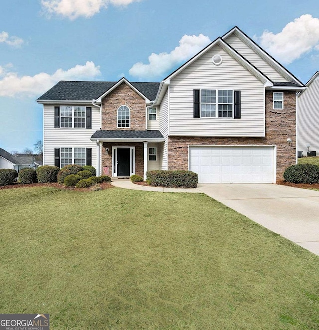 view of front of home with a garage and a front yard