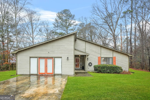 view of front of property with french doors, a patio area, and a front yard