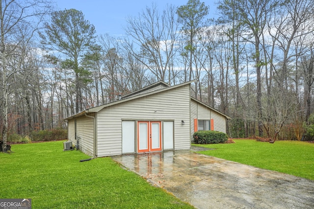 view of outbuilding featuring french doors, a yard, and central AC