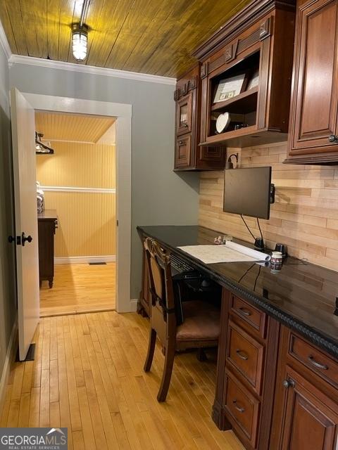 office space with crown molding, wooden ceiling, and light wood-type flooring