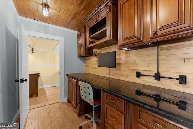 office with crown molding, built in desk, light wood-type flooring, and wooden ceiling