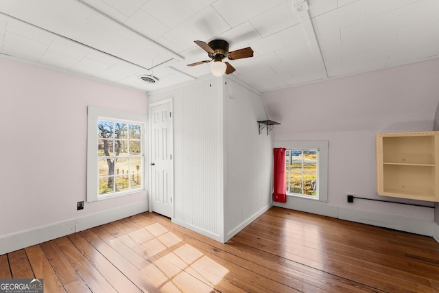 additional living space with wood-type flooring and ceiling fan