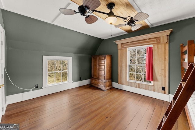 bonus room with ceiling fan, wood-type flooring, a healthy amount of sunlight, and vaulted ceiling