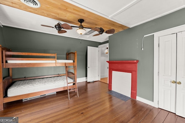 unfurnished bedroom featuring hardwood / wood-style floors and ceiling fan