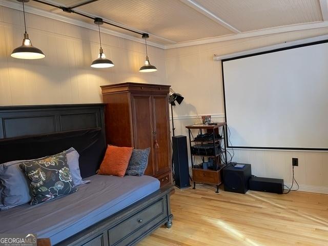 bedroom featuring ornamental molding and light hardwood / wood-style flooring