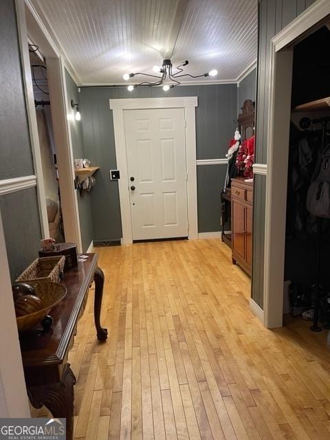 interior space with ornamental molding and light hardwood / wood-style floors