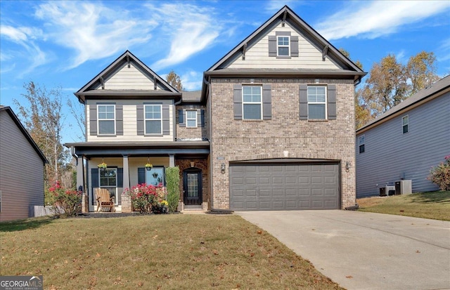 craftsman-style house with driveway, a garage, a front lawn, and brick siding