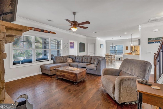 3890 Pleasant Woods Dr, Cumming, GA 30028 - living room with ornamental molding, dark wood-type flooring, visible vents, and baseboards