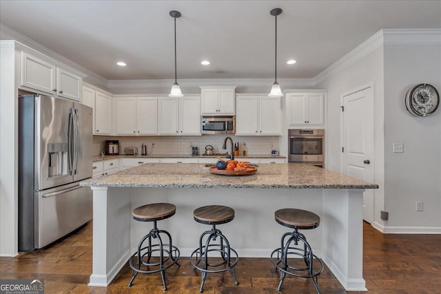 3890 Pleasant Woods Dr, Cumming, GA 30028 - kitchen featuring dark wood finished floors, stainless steel appliances, decorative backsplash, ornamental molding, and white cabinetry