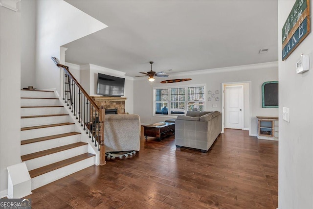 3890 Pleasant Woods Dr, Cumming, GA 30028 - living area featuring hardwood / wood-style flooring, a fireplace, a ceiling fan, stairs, and ornamental molding