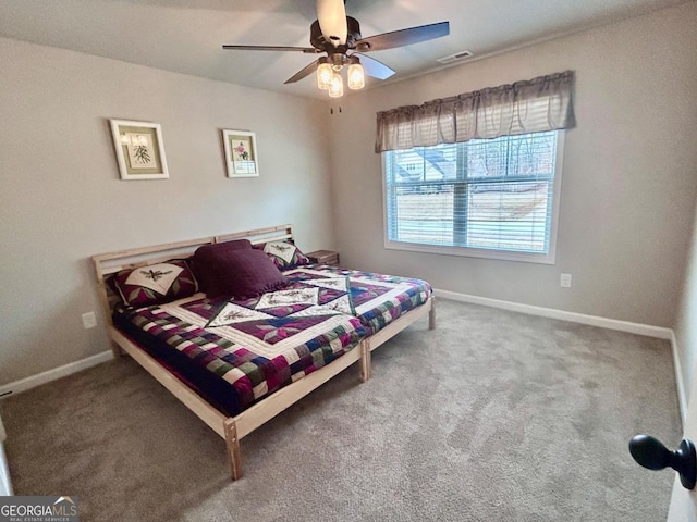 carpeted bedroom with baseboards, visible vents, and ceiling fan