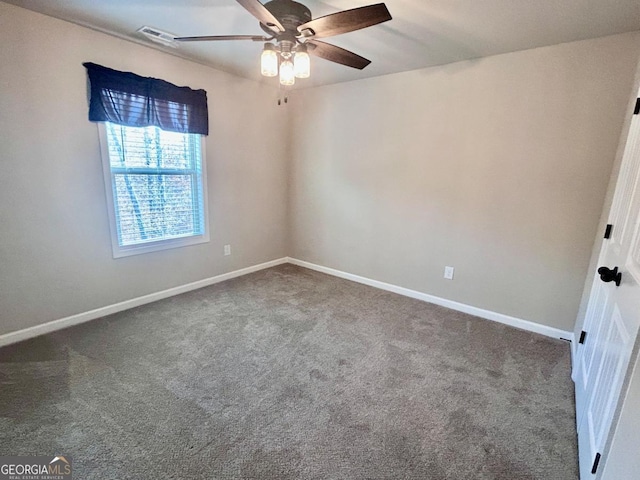empty room featuring carpet flooring, baseboards, visible vents, and a ceiling fan