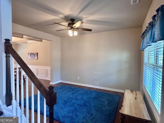 spare room with visible vents, baseboards, ceiling fan, stairs, and wood finished floors