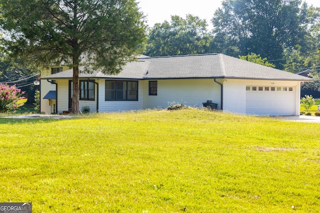 ranch-style home featuring a garage and a front lawn