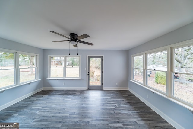 unfurnished sunroom with ceiling fan