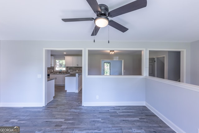 spare room featuring ceiling fan, dark hardwood / wood-style flooring, and sink