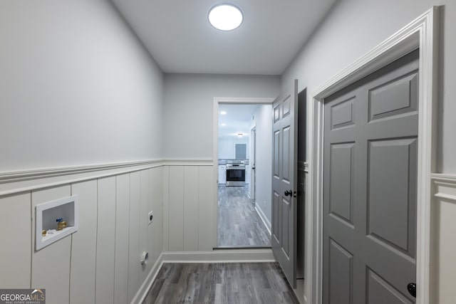 laundry area featuring hookup for a washing machine and hardwood / wood-style floors