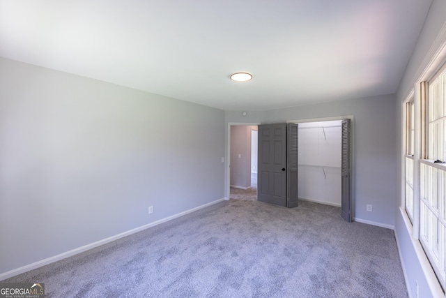 unfurnished bedroom with carpet floors and a closet