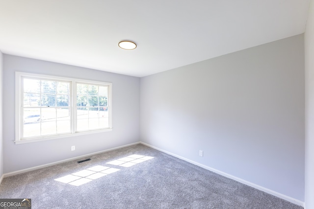 unfurnished room with carpet flooring