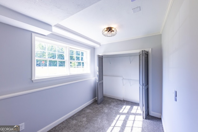 unfurnished bedroom with crown molding and light colored carpet