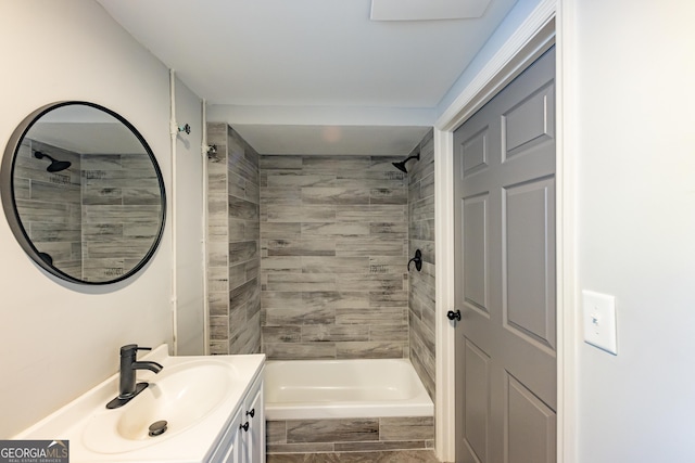 bathroom featuring vanity and tiled shower / bath combo