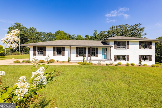 view of front of home with a porch and a front lawn