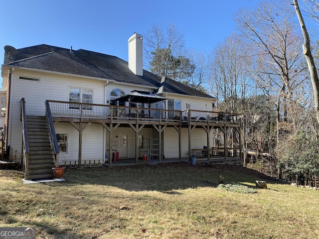 back of property featuring a deck and a lawn