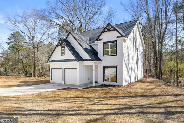 modern farmhouse style home featuring driveway, a front lawn, a garage, and a shingled roof