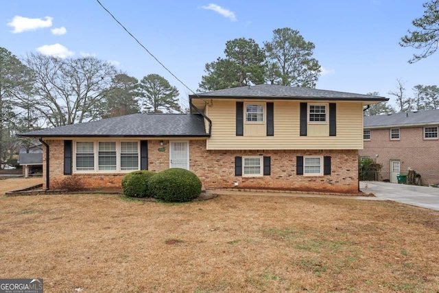 tri-level home with a front lawn