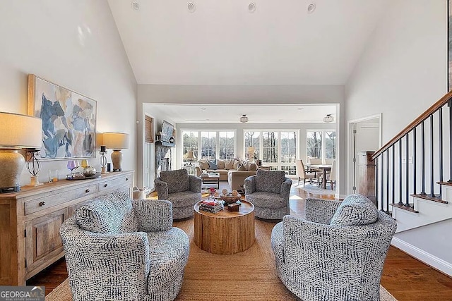 living room with hardwood / wood-style flooring and high vaulted ceiling