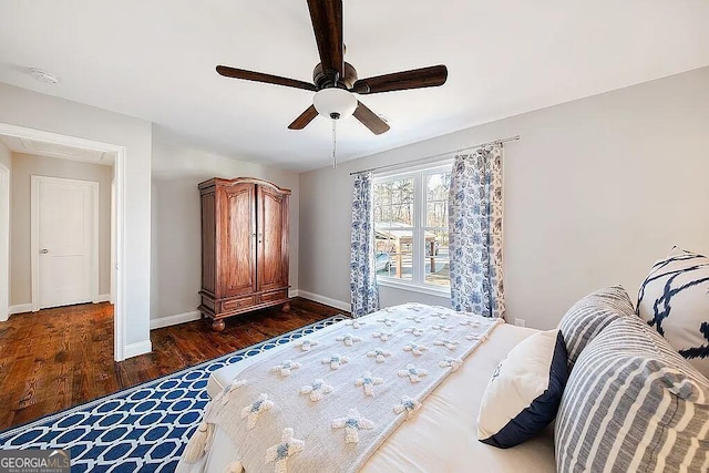 bedroom with dark wood-type flooring and ceiling fan