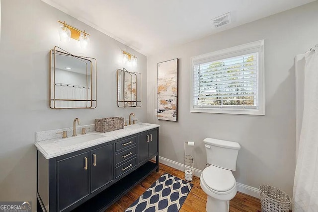 bathroom with vanity, hardwood / wood-style flooring, and toilet