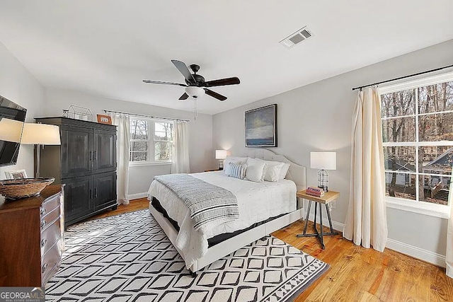 bedroom featuring light hardwood / wood-style floors and ceiling fan