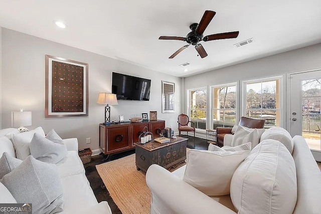 living room with a healthy amount of sunlight and ceiling fan