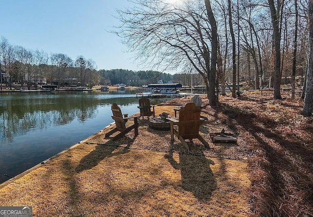 exterior space featuring a fire pit and a water view