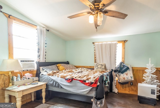 bedroom featuring vaulted ceiling, dark hardwood / wood-style floors, heating unit, and ceiling fan