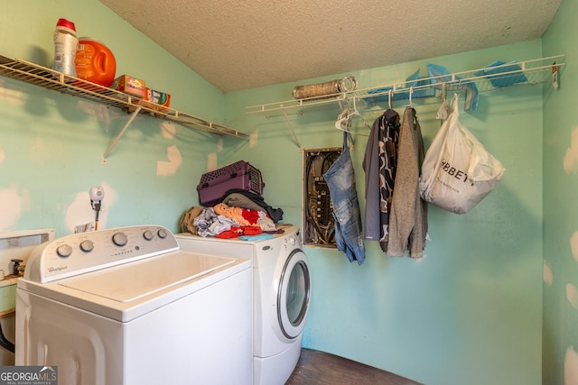 washroom with washer and dryer and a textured ceiling