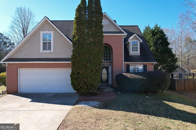 view of property with a garage and a front lawn