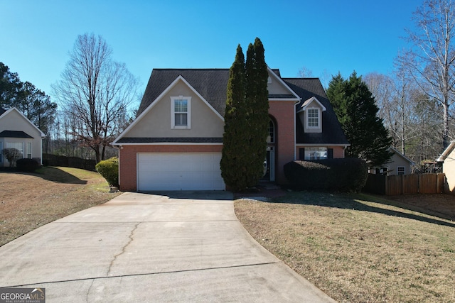 view of property with a garage and a front yard