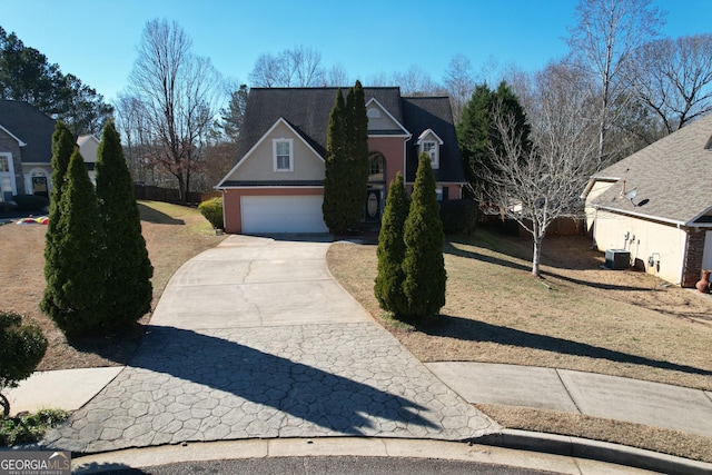 view of front property with a garage and central air condition unit