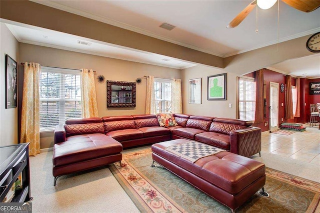 tiled living room with ornamental molding and ceiling fan