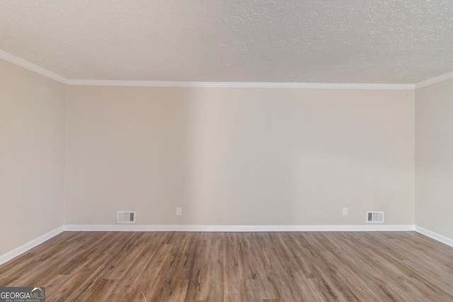 spare room with crown molding, hardwood / wood-style flooring, and a textured ceiling