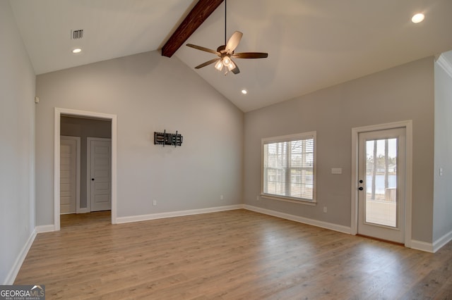 unfurnished living room featuring ceiling fan, high vaulted ceiling, light hardwood / wood-style floors, and beamed ceiling
