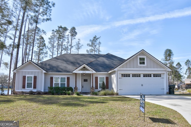 view of front of property featuring a garage and a front yard