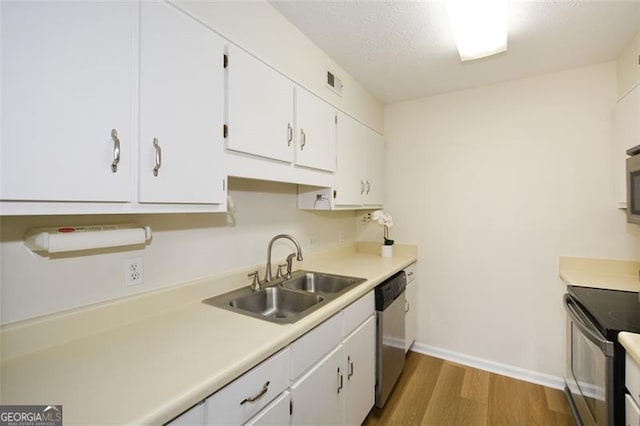 kitchen featuring sink, wood-type flooring, white cabinets, black range with electric cooktop, and stainless steel dishwasher